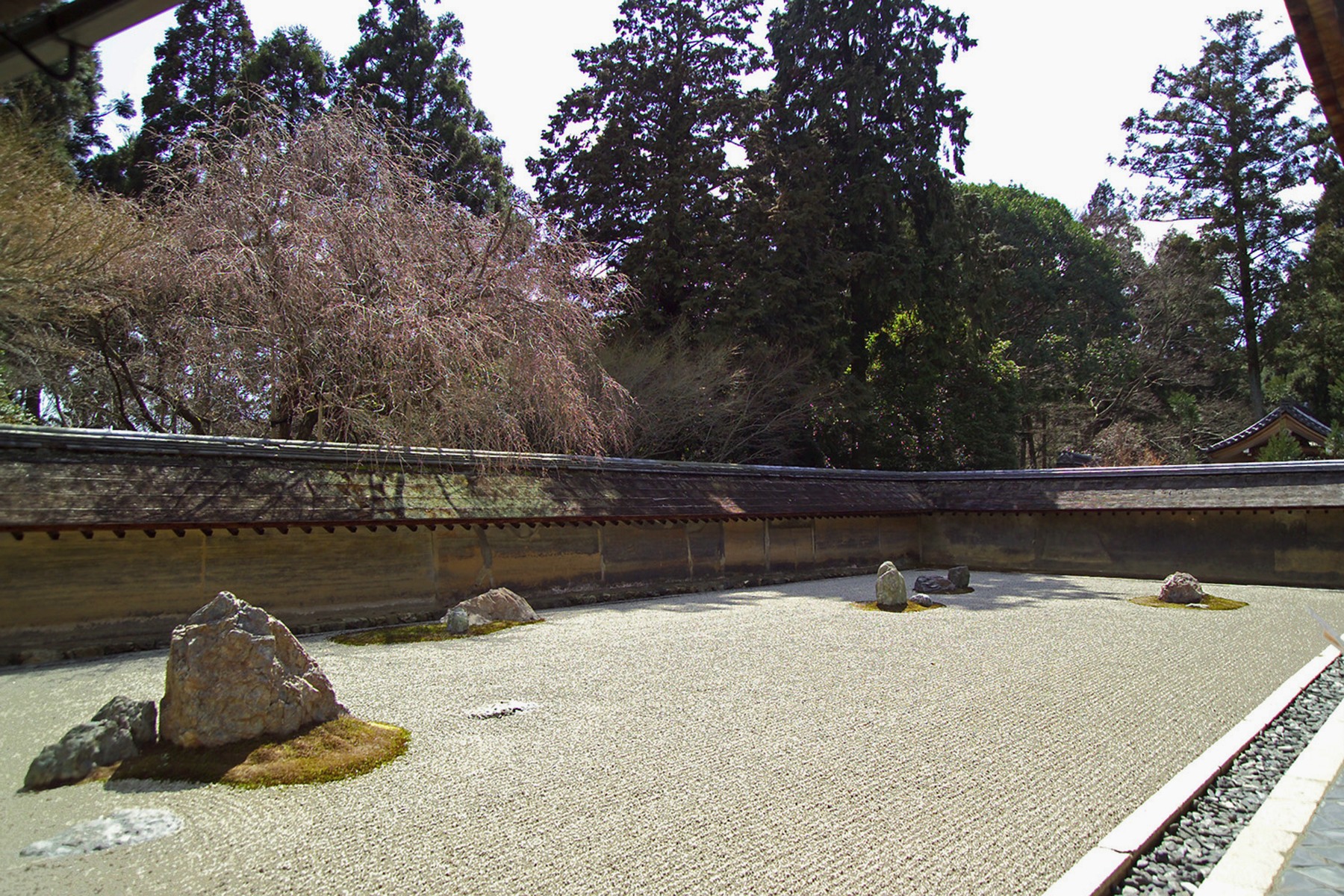 Stone groupings and raked white gravel in the dry landscape garden at Ryōan-ji, Kyoto